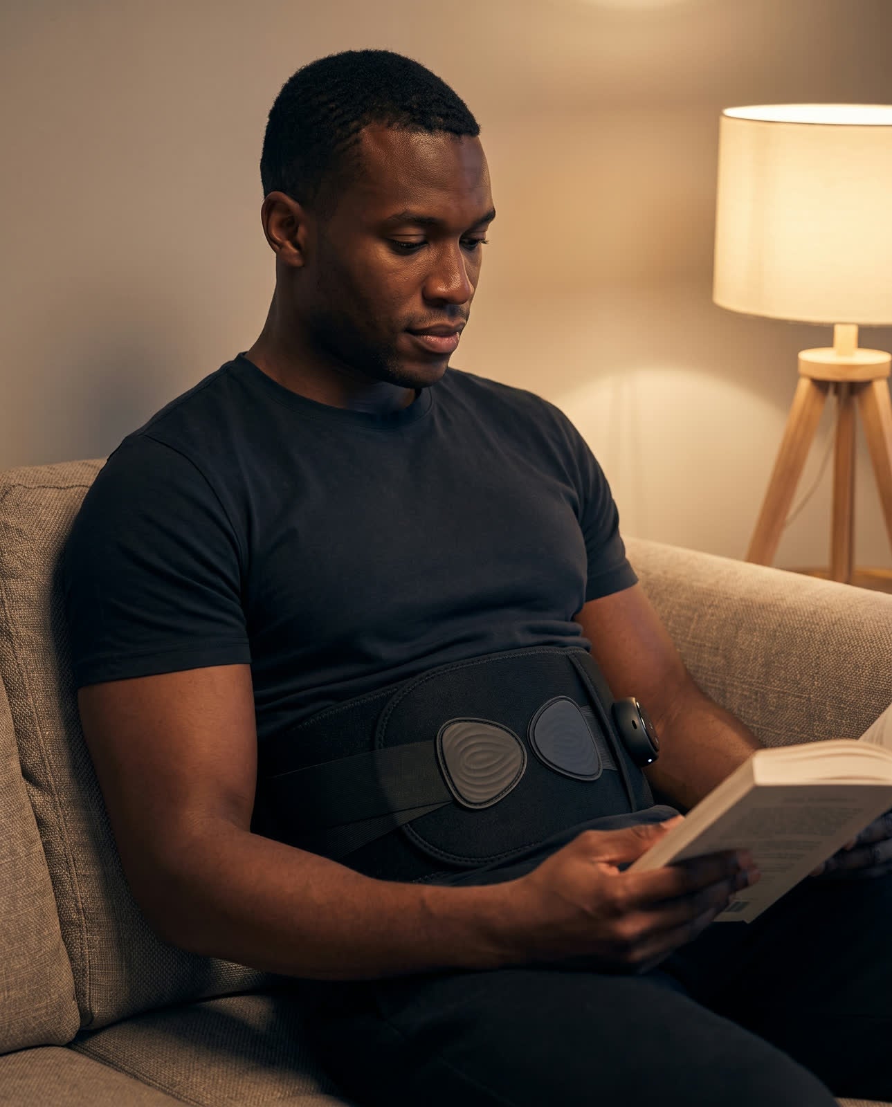Wearing the belt on the couch in the evening with one lamp on